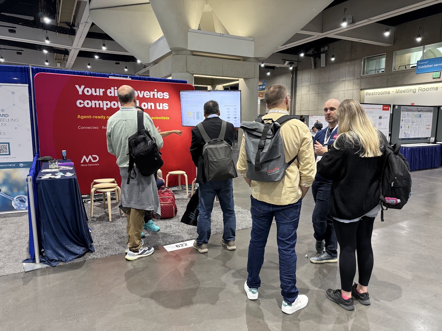 Mass Dynamics at the booth, crowd gathered for a live demo